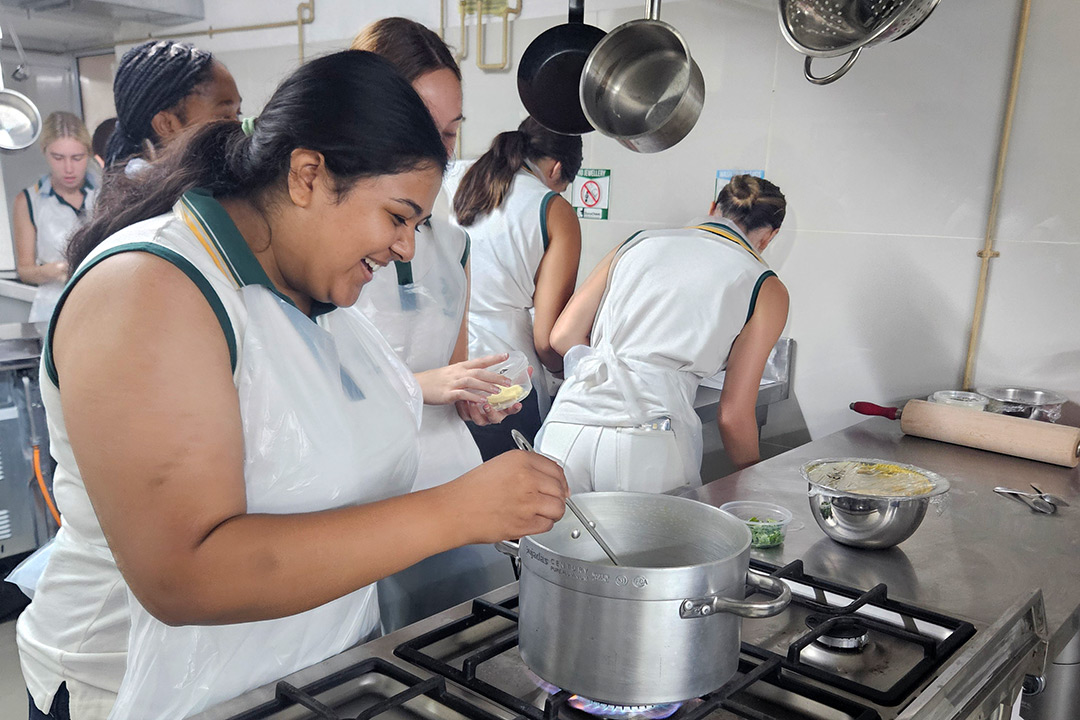 Danville girls cooking at Caraway International